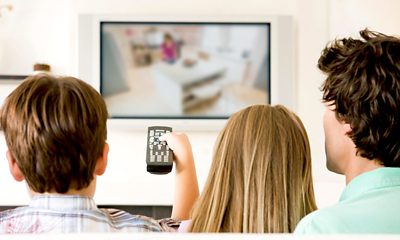 Three people watching TV