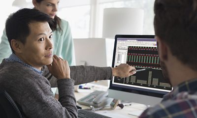 Architects meeting working at computer in office