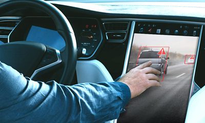 Man using tablet while driving car
