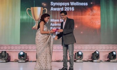 Man giving award to woman on stage