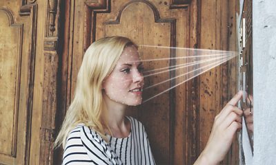 Woman Using Computer Vision Smart Doorbell at Home