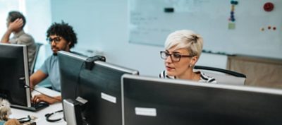 Short haired computer programmer working on a new software in the office