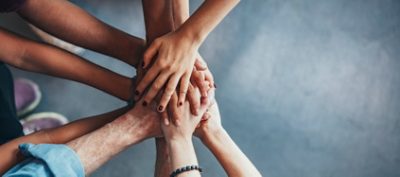 Group of Hands Collaborating on a Cybersecurity Project