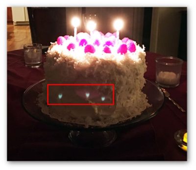 Ghost example: Picture Photo taken with a cell phone camera that clearly shows three sharply focused ghost images of the candle flames. There is also a fourth, extended ghost image centered on the middle sharp ghost image. | ϲֱ