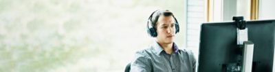 Man with headphones looking at computer