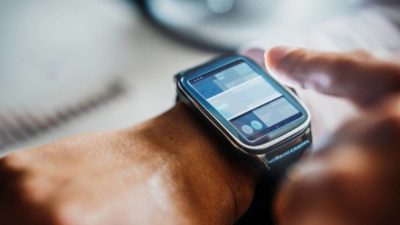 Person using smart watch to check stock exchange prices