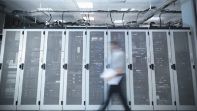 Person walking in front of data center