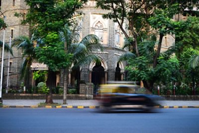 Car driving in front of building
