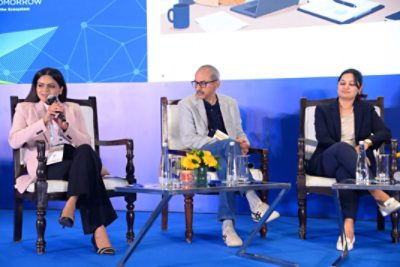 This is the photo of three seated panelists shown first.